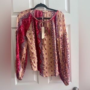 Beautiful, never worn Love Stitch blouse! Tags are still on. It is a size small.